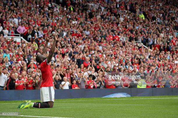 Romelu Lukaku celebrates in front of Manchester United supporters.