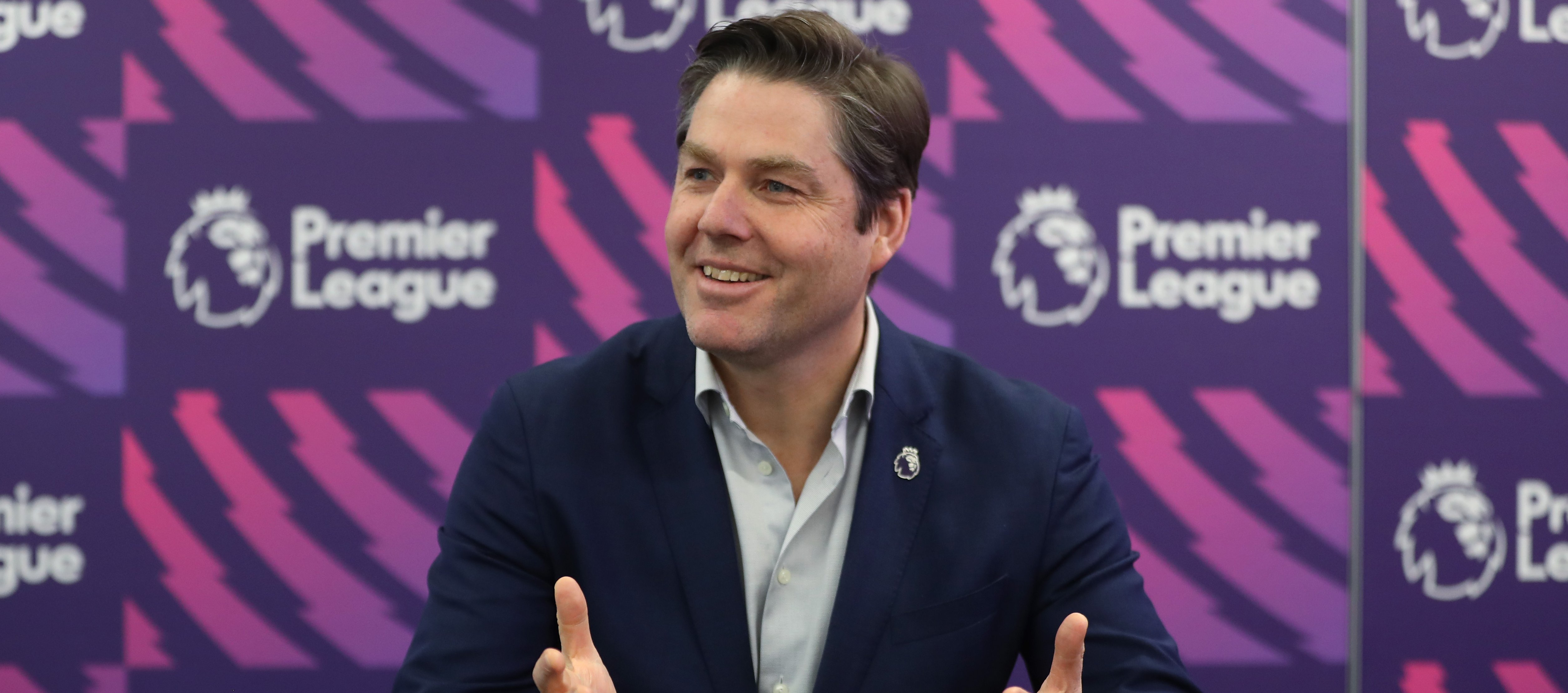 Premier League chief executive Richard Masters speaking in front of a Premier League backdrop.