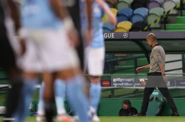 Pep Guardiola walks along the touchline after Manchester City's Champions League defeat to Lyon.