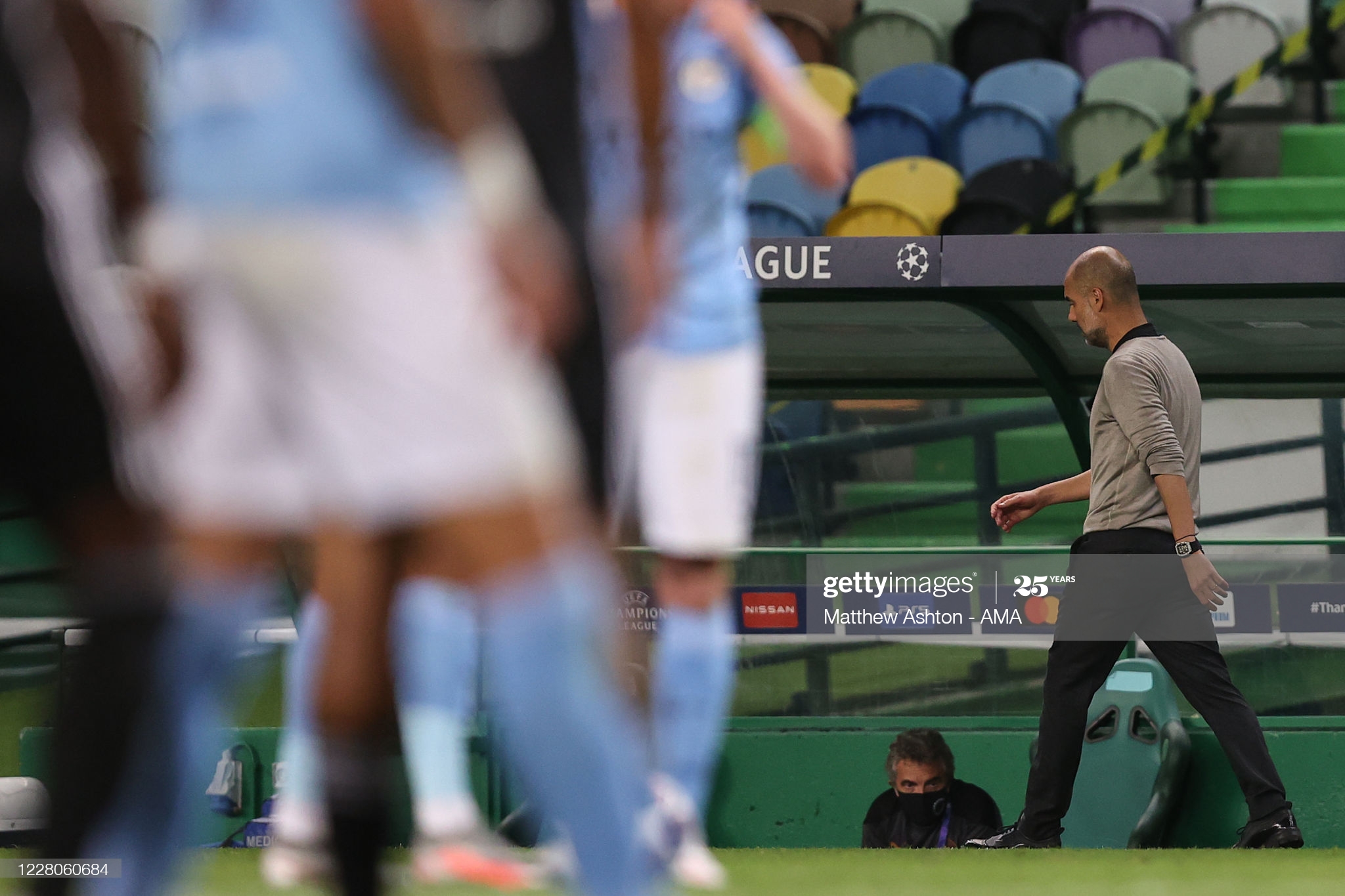 Pep Guardiola walks along the touchline after Manchester City's Champions League defeat to Lyon.