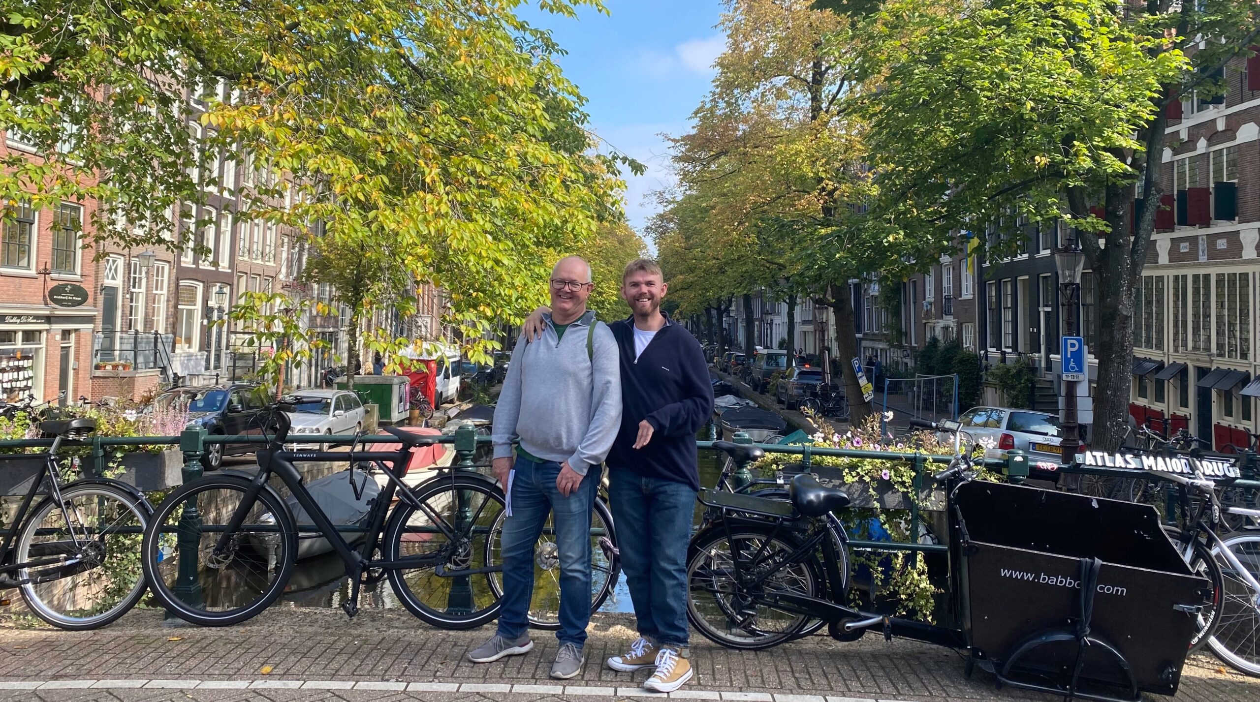 Jake Jones standing with his dad on a canal bridge during a day out in Amsterdam.