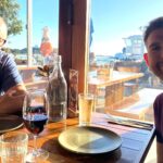 Jake Jones sitting with his dad at a restaurant during a trip to Melbourne, Australia.