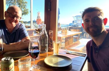 Jake Jones sitting with his dad at a restaurant during a trip to Melbourne, Australia.