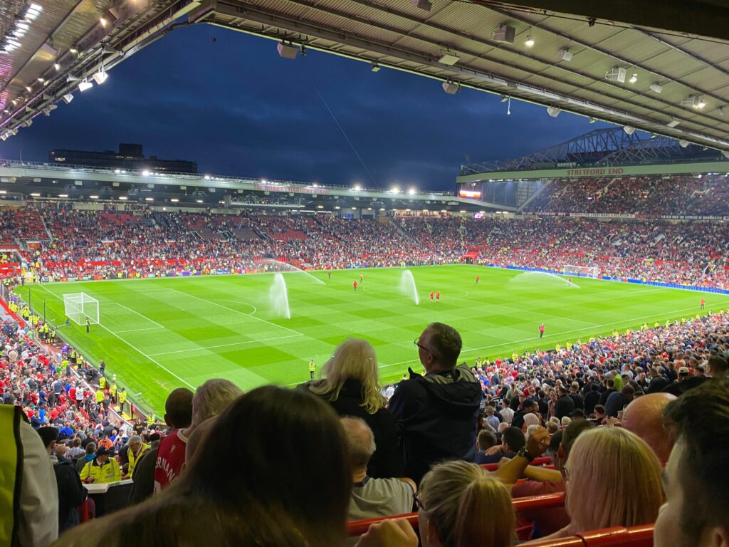 View across the Old Trafford pitch towards the Sir Bobby Charlton Stand and Stretford End.