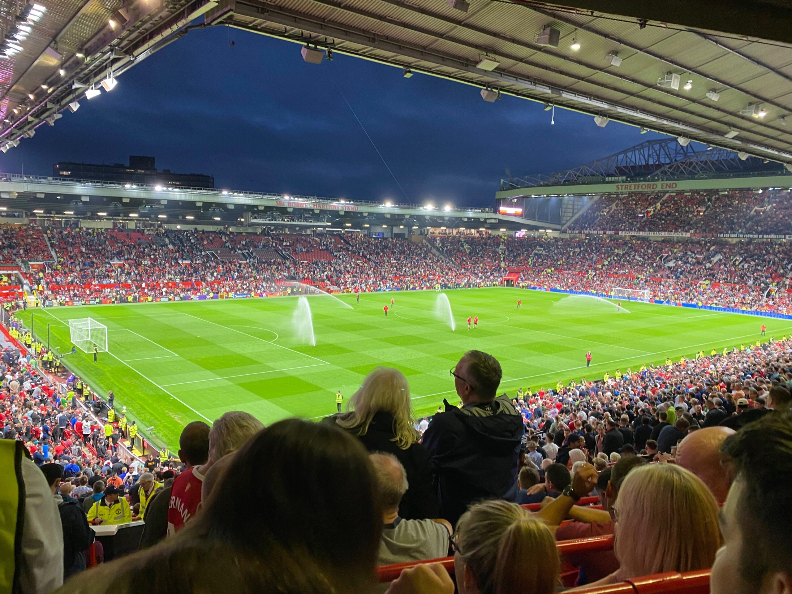 View across the Old Trafford pitch towards the Sir Bobby Charlton Stand and Stretford End.